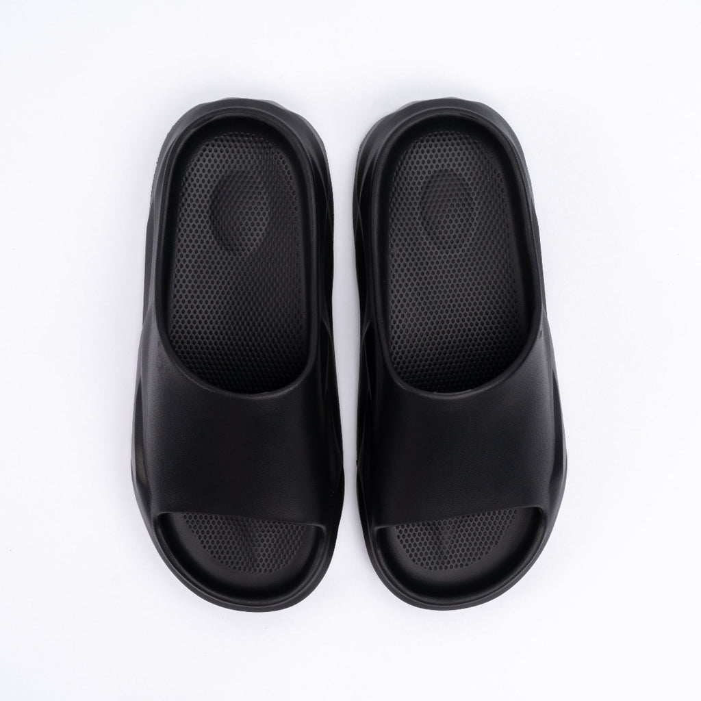 Pair of black slippers on a white background