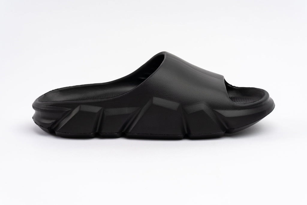 Black slide sandal on a white background