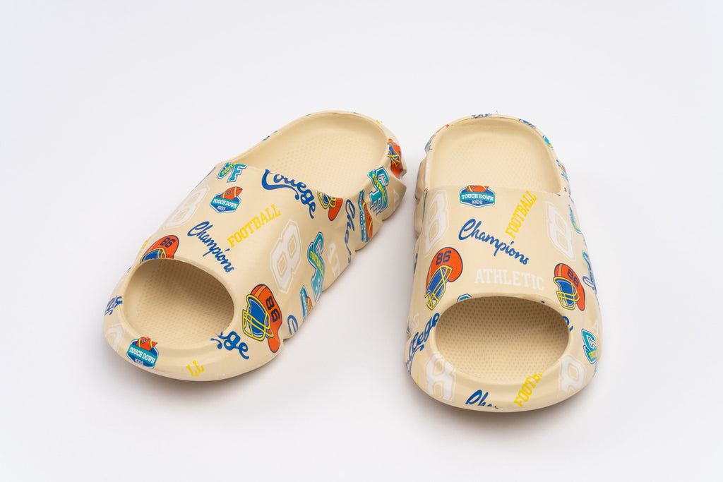 Pair of beige clogs with colorful branding on a white background
