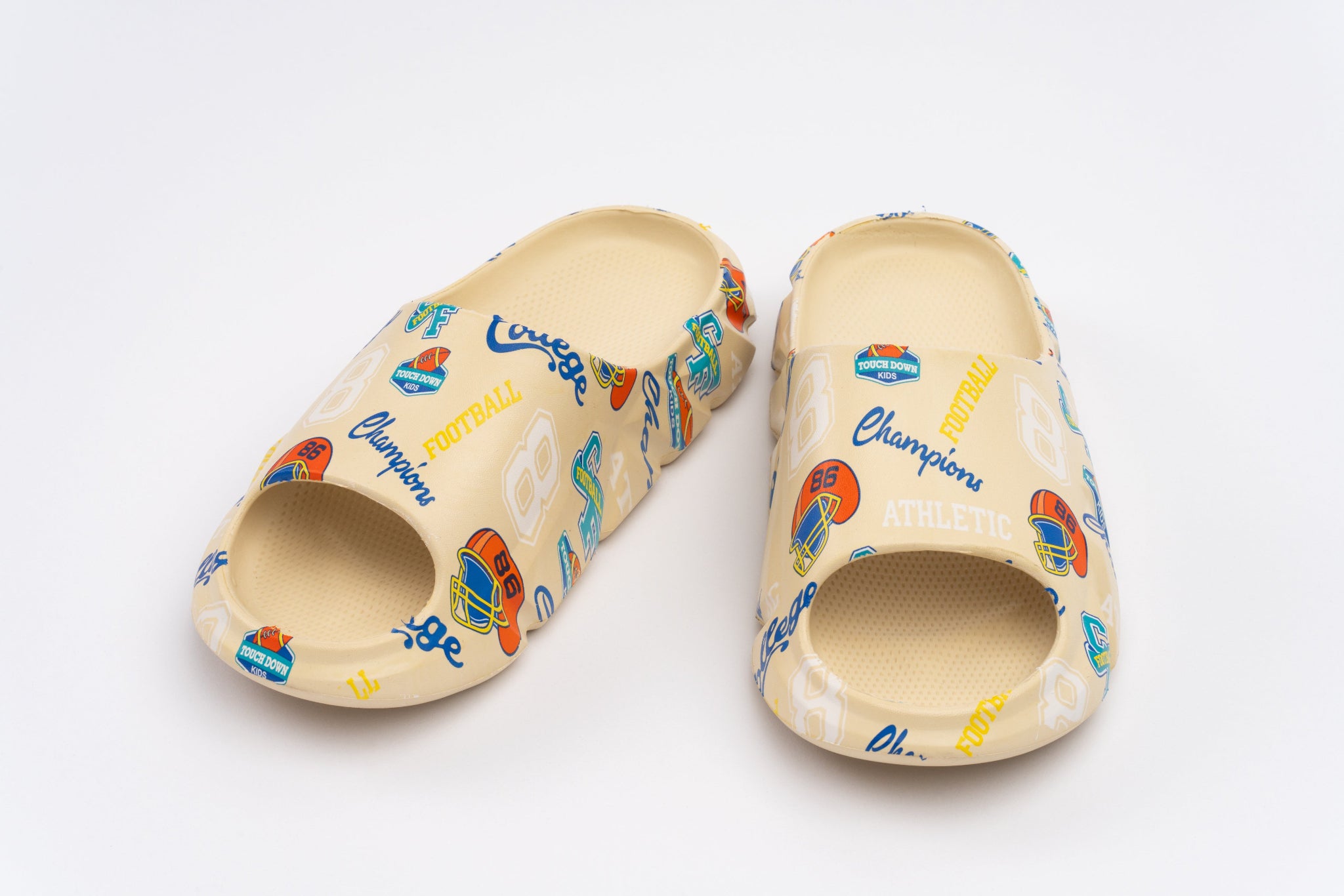 Pair of beige clogs with colorful branding on a white background