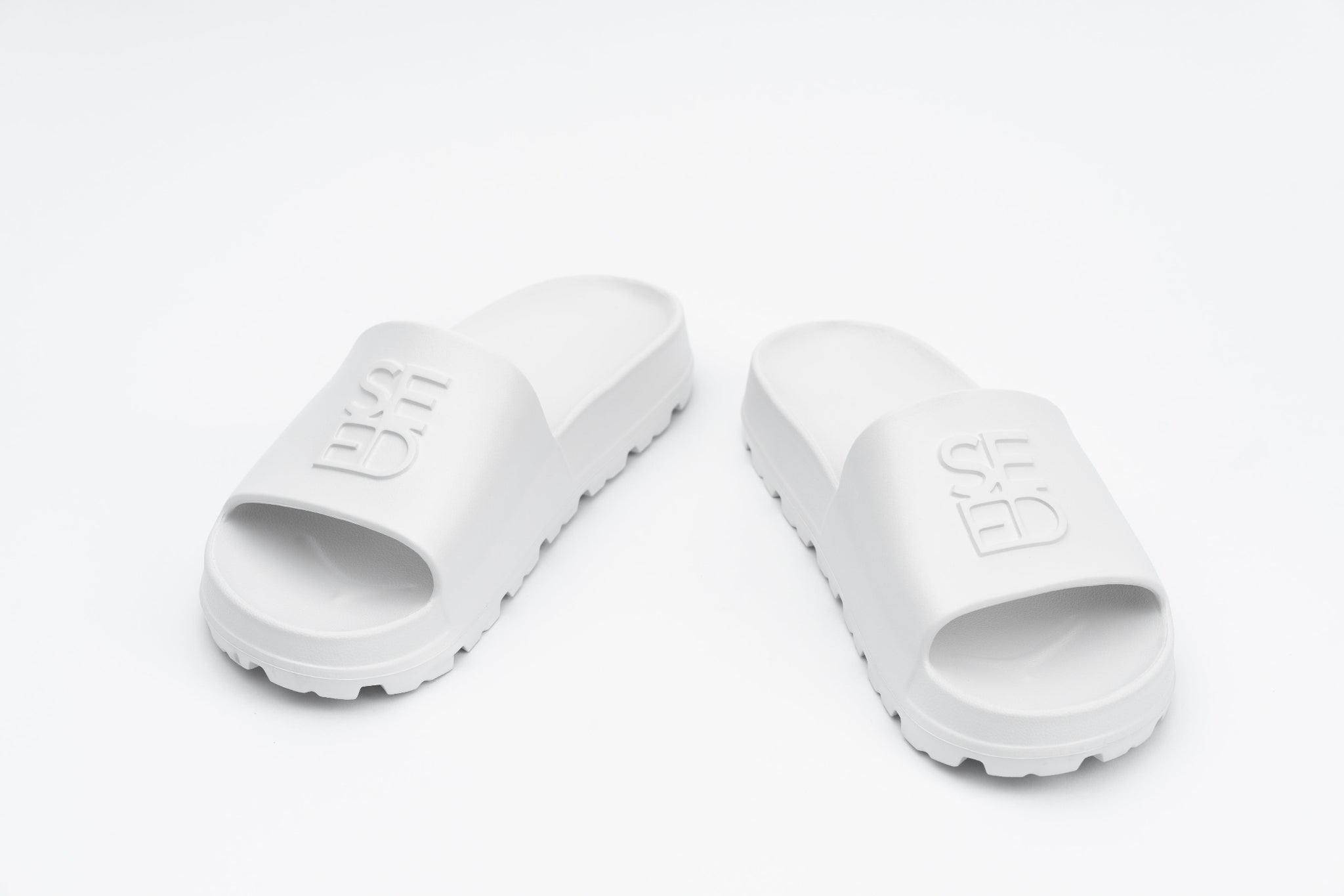 White slides with brand logo on a white background