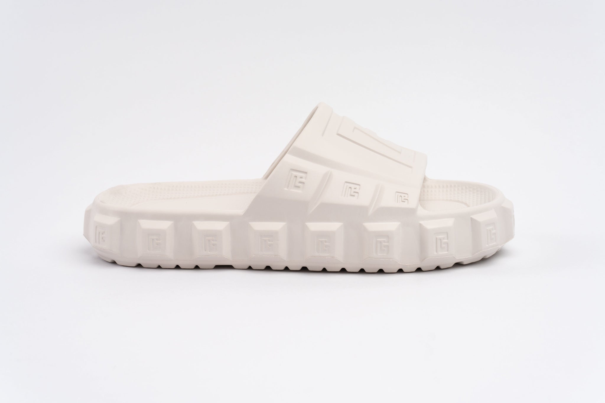 White slide sandal with brand logo on a white background