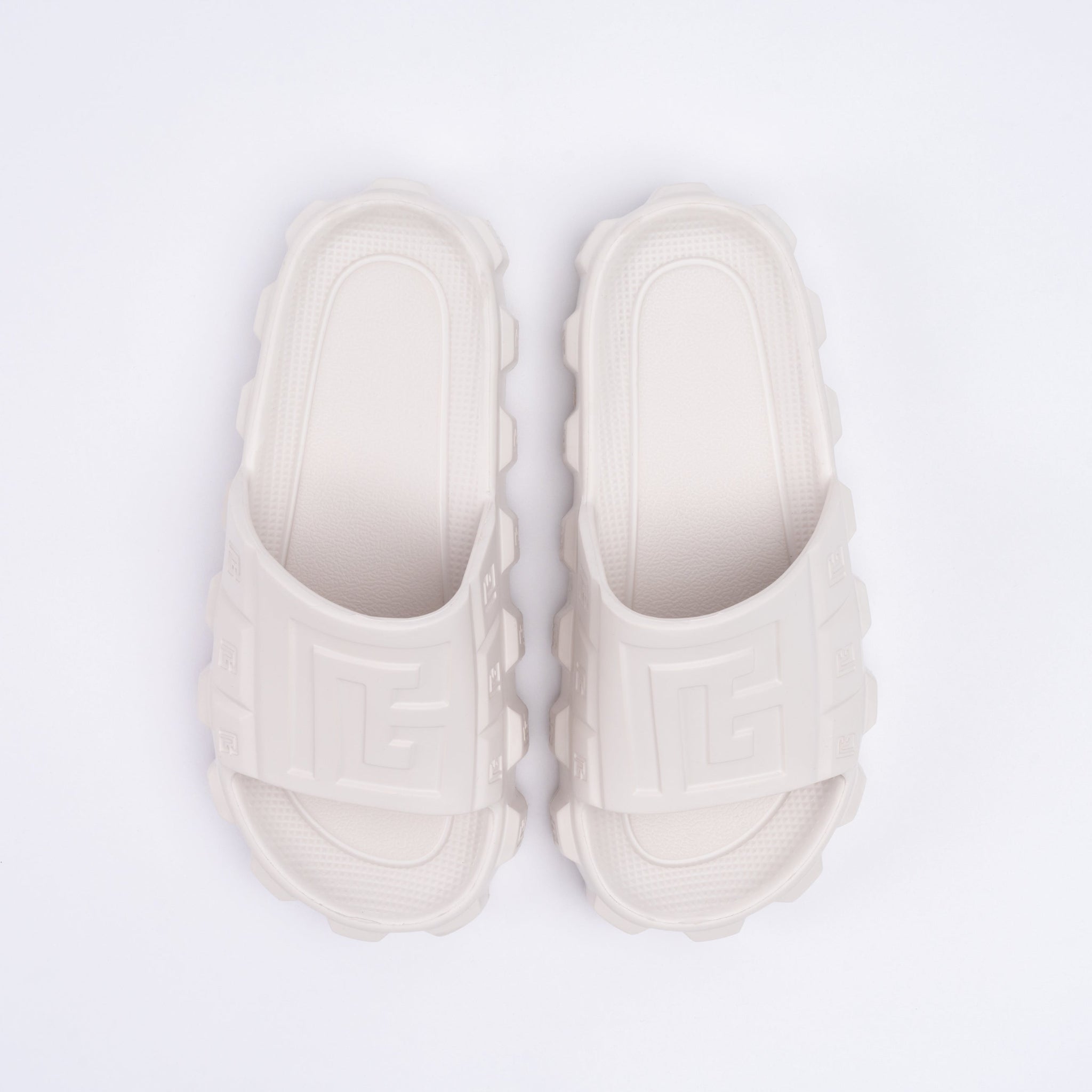 Pair of white sandals on a light gray background