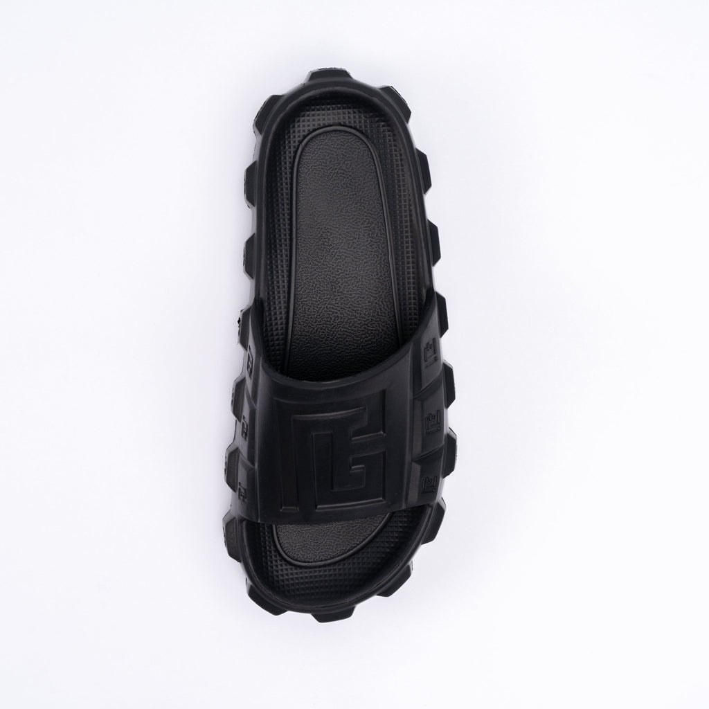 Black rubber slide sandal on a white background