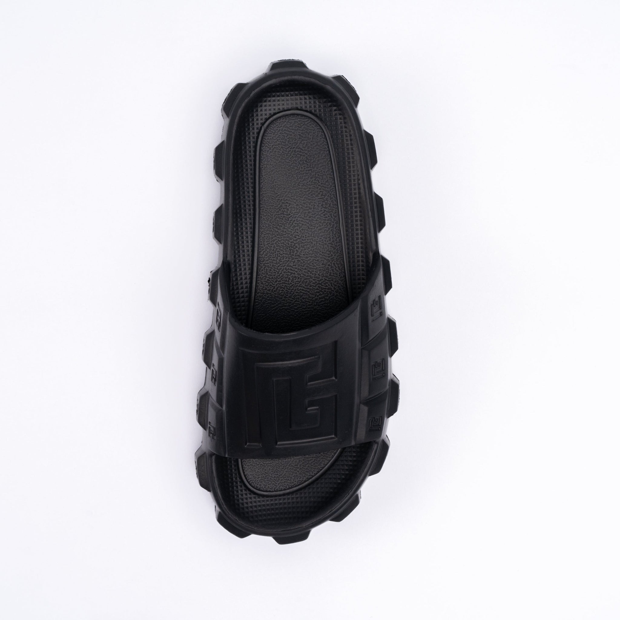 Black rubber slide sandal on a white background