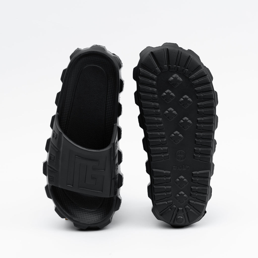 Black rubber sandals with thick soles on a white background