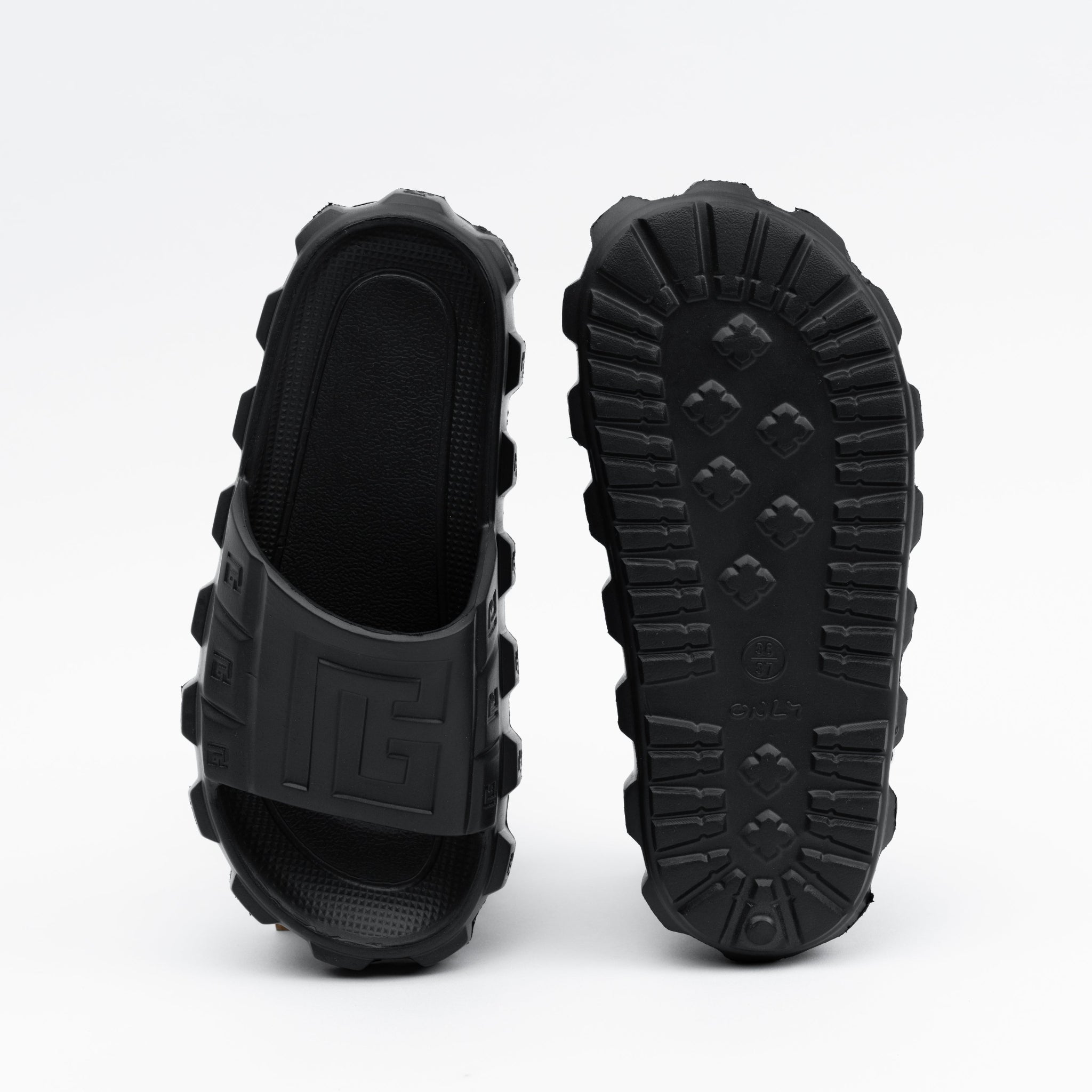 Black rubber sandals with thick soles on a white background