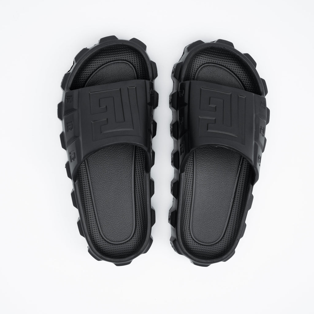 Pair of black rubber sandals on a white background