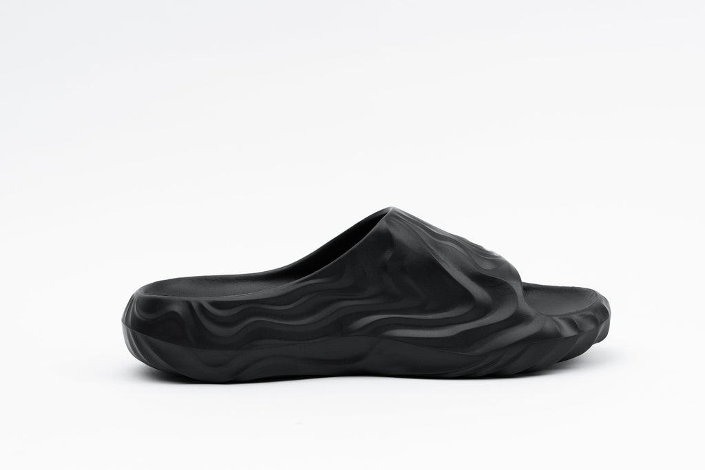 Black slide sandal on a white background