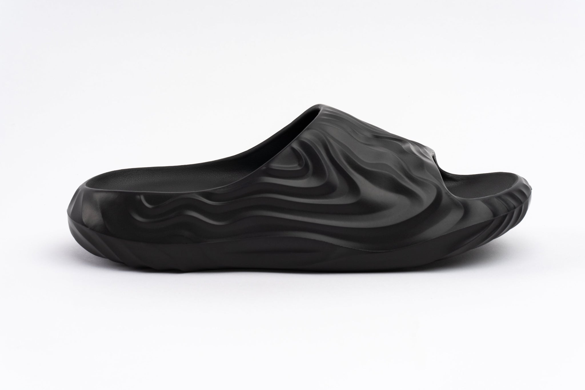 Black slipper with wavy texture on a white background