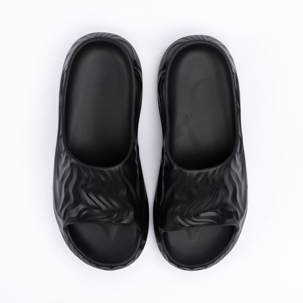 Pair of black slides with zebra pattern on a white background